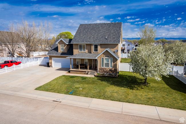 Traditional home featuring stucco siding, fence, covered porch, and concrete driveway | Image 42