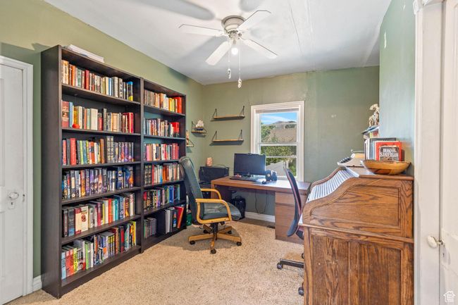 Office space with a ceiling fan, carpet, and baseboards | Image 14