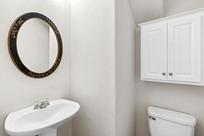 Half bathroom featuring toilet and a sink | Image 16