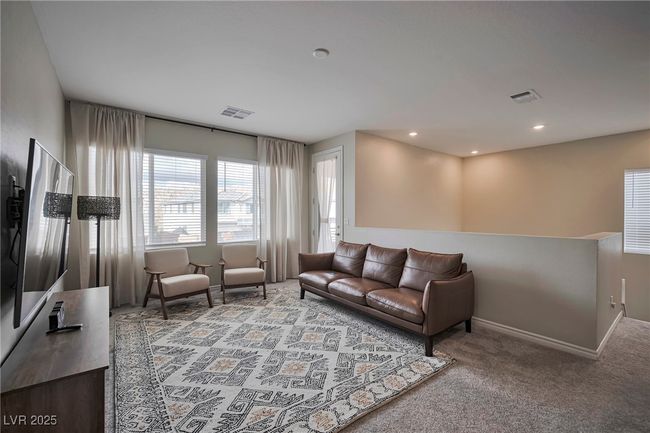 Carpeted living room featuring baseboards, visible vents, and recessed lighting | Image 13