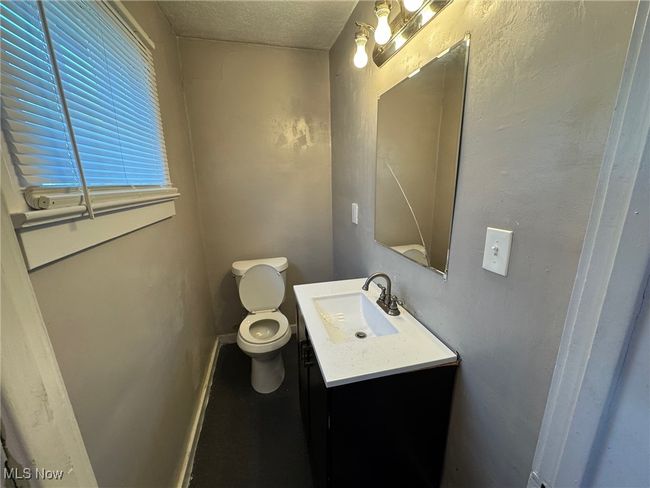 Bathroom with a textured ceiling, toilet, and vanity | Image 9