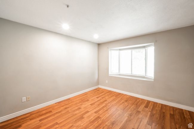 Empty room with light wood-type flooring and recessed lighting | Image 11
