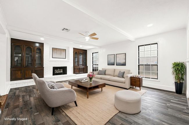 Virtually Staged:The living room features a fireplace, built in cabinetry and tons of natural light. | Image 11