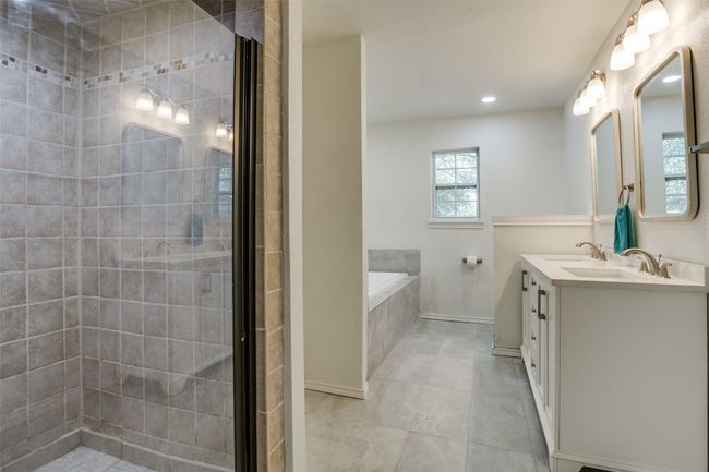 Bathroom featuring a bath, double vanity, a shower stall, tile patterned flooring, and recessed lighting | Image 19