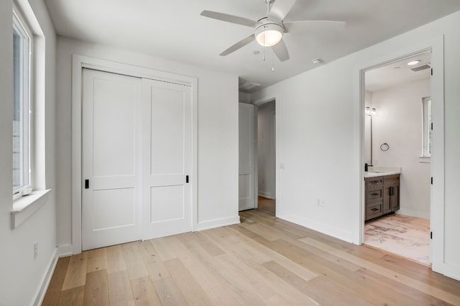 Unfurnished bedroom with light wood-style floors, a closet, baseboards, and multiple windows | Image 16