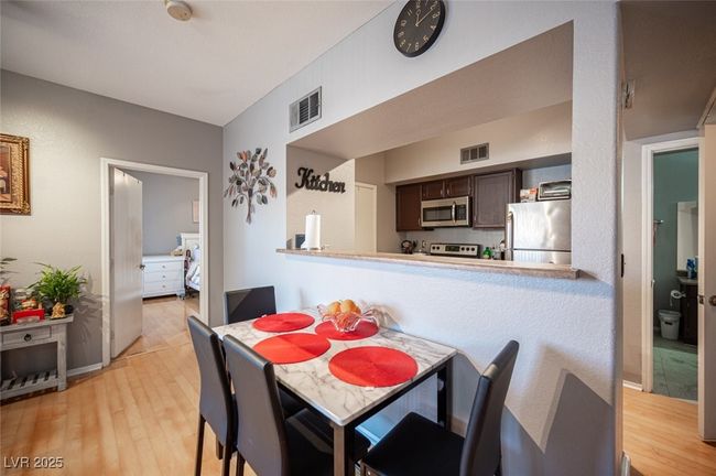 Dining area with visible vents and light wood-style flooring | Image 12