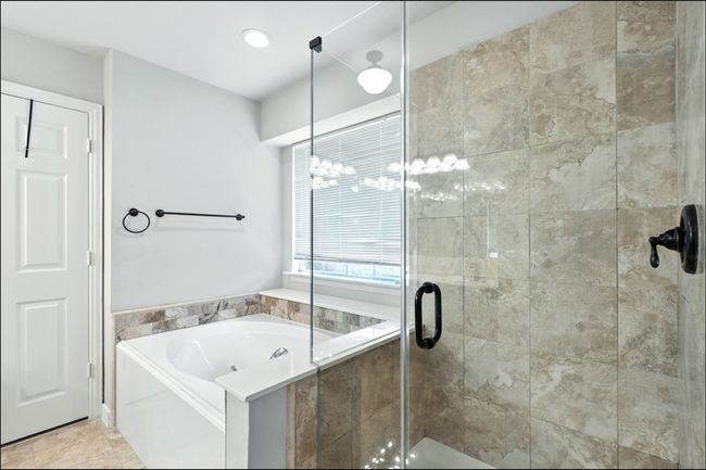 Full bath featuring a garden tub and a stall shower | Image 30