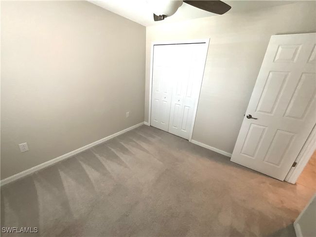 Unfurnished bedroom with carpet, a closet, and ceiling fan | Image 15