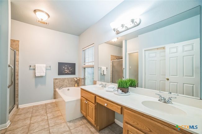 Vanity with 2 sinks, a large soaking tub and separate shower. | Image 10