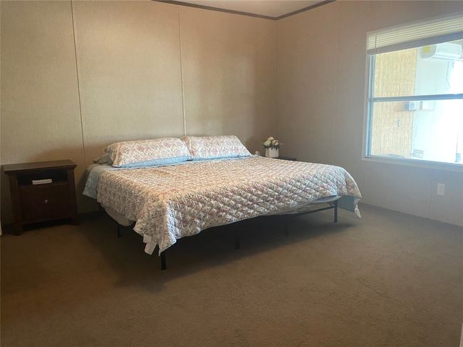 Carpeted bedroom featuring a decorative wall | Image 6