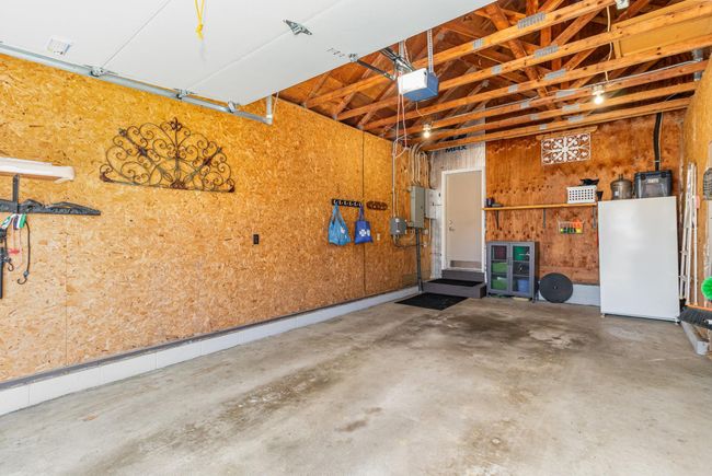 The oversized attached 1-car garage provides access to the home & the sunroom. Two electrical panels are housed here - the main 200 amp & the 50 amp for the sunroom. The garage door opener is a MyQ smart opener. | Image 32