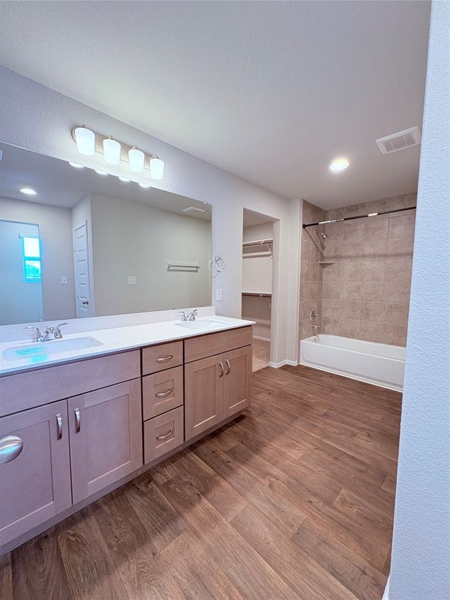 Bathroom featuring wood finished floors, visible vents, a sink, and double vanity | Image 30