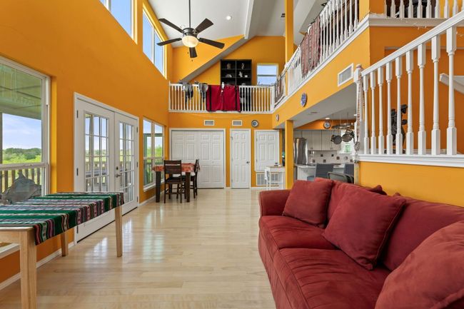 Living area with visible vents, french doors, a ceiling fan, and wood finished floors | Image 13