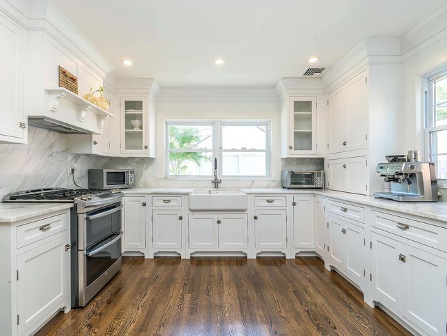 Kitchen featuring stainless steel appliances, a sink, white cabinets, decorative backsplash, and recessed lighting | Image 10