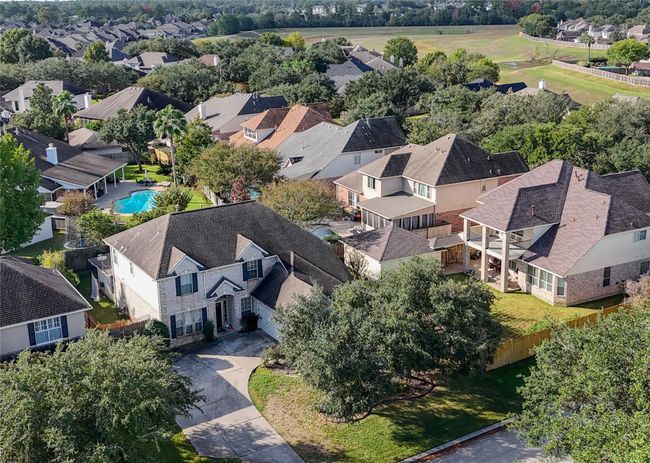 Spacious suburban neighborhood with well-maintained homes, featuring mature trees. The area is peaceful and inviting. Ideal for families seeking a community setting. | Image 31