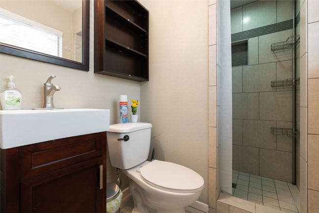 Bathroom with toilet, a stall shower, and vanity | Image 11