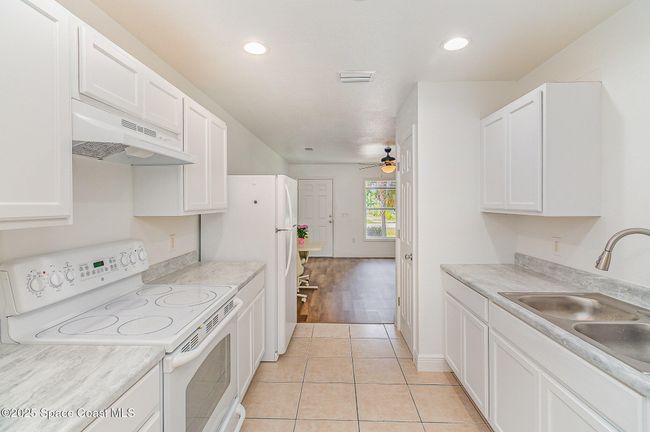 Unit #1232 Kitchen is fully updated with tile flooring. | Image 9