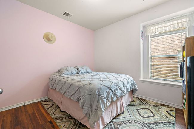 Bedroom with baseboards, wood finished floors, and windows | Image 20