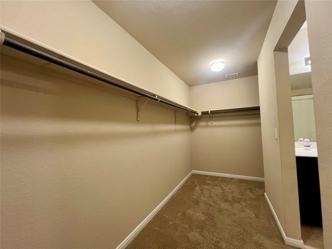 Walk in closet featuring carpet | Image 19