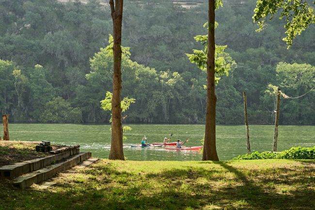 View of property's community featuring a view of trees, a lawn, and a water view | Image 16