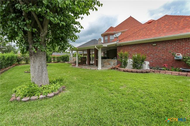 Spacious backyard with mature trees and thick grass | Image 41