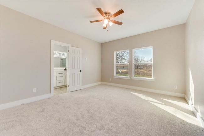 Empty room featuring a ceiling fan and light colored carpet | Image 23