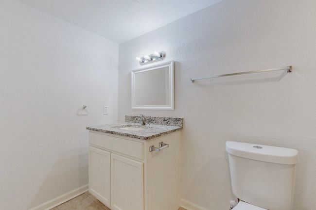 Bathroom with vanity, tile patterned floors, and toilet | Image 22
