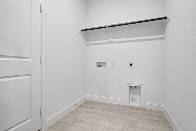 Laundry room with hookup for an electric dryer, hookup for a washing machine, and light wood-type flooring | Image 10