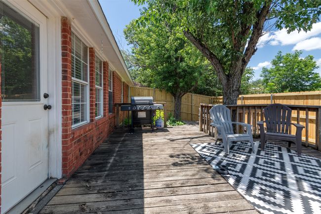 Wooden deck featuring a fenced backyard and grilling area | Image 21