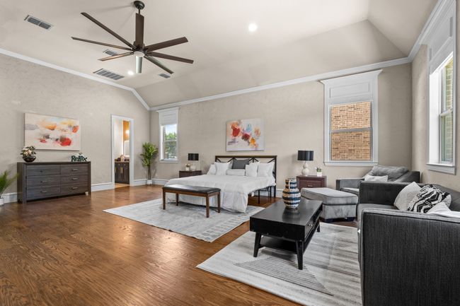 Bedroom featuring lofted ceiling, wood finished floors, ornamental molding, and ceiling fan | Image 13