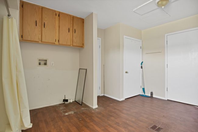 Laundry room with dark wood-style flooring, washer hookup, and baseboards | Image 24