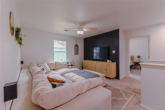 View of the loft from the primary bedroom. View also into an additional secondary bedroom. The loft would make an excellent gym or playroom as well! | Image 23