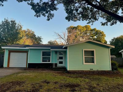 Single story home with a garage and a front yard | Image 1