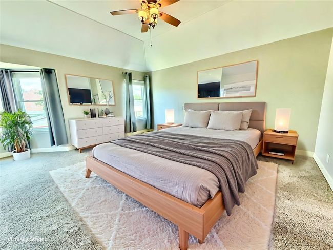 Carpeted bedroom featuring multiple windows and ceiling fan | Image 13