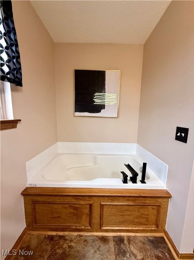 Full bath with baseboards and a garden tub | Image 20