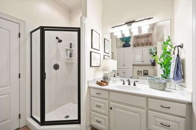 Bathroom with an enclosed shower, vanity, and crown molding | Image 23