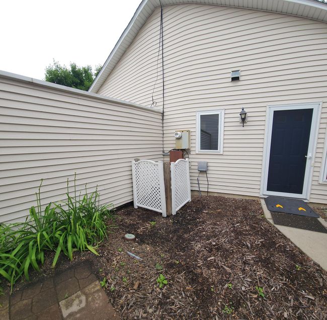 Patio area between garage and home. Nicely kept! | Image 15