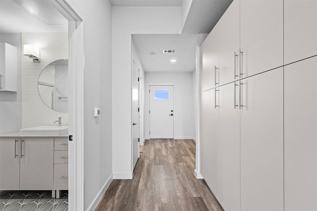 Hall with a sink, dark wood-style flooring, and baseboards | Image 8