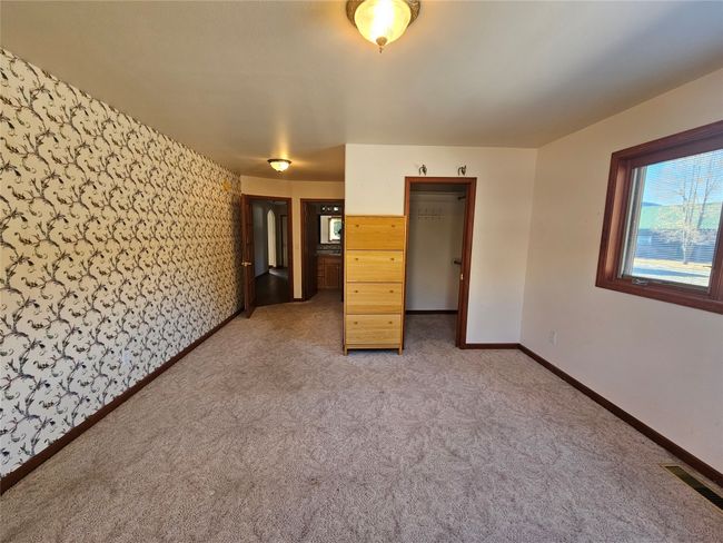 The primary bedroom has an attached bathroom and a walk-in closet plus excellent views of the outdoors. | Image 16