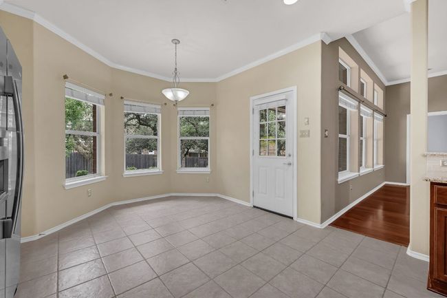 Enjoy both formal and casual dining with a dedicated dining room and a charming breakfast nook. | Image 13