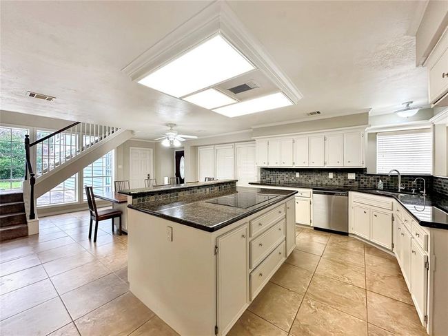 Island is also designed with a lifted counter to add in high top stools for additional seating | Image 12