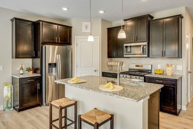 The kitchen is beautiful with it's granite countertops, ceramic backsplash and stainless appliances. | Image 4