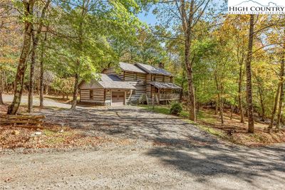 Embrace serene mountain living with easy access to the towns of West Jefferson and Boone from your antique log home located in the charming neighborhood of Stonebridge. | Image 1