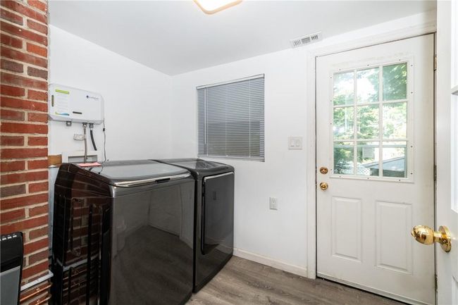 washing machine and dryer/door going to the backyard | Image 4