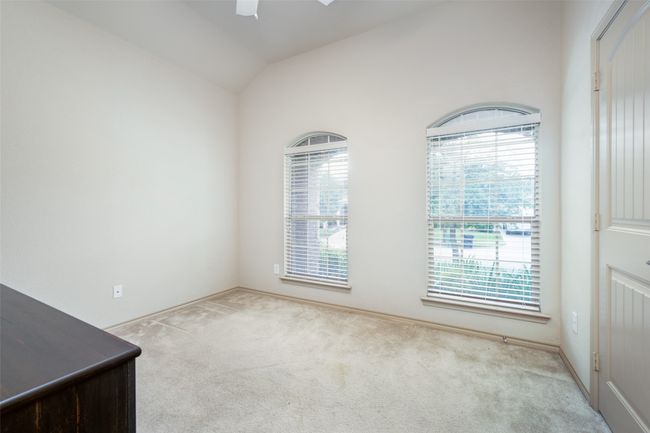 Empty room featuring a ceiling fan, carpet floors, and vaulted ceiling | Image 14
