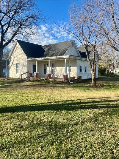 Rear view of property featuring covered porch and a yard | Image 2