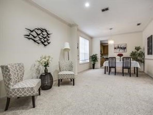 Living area with carpet and ornamental molding | Image 15