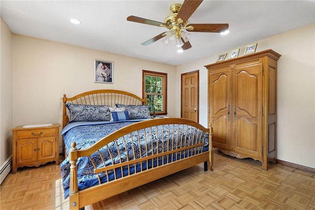 Bedroom featuring ceiling fan and light parquet flooring | Image 14