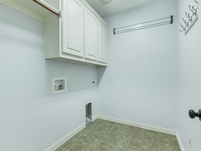 Laundry area featuring cabinet space, washer hookup, and electric dryer hookup | Image 24