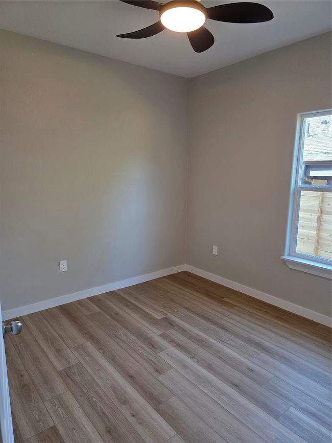 Secondary bedroom featuring ceiling fan, wood finished floors, and baseboards | Image 8